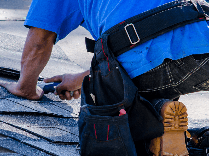 A commercial roofing specialist working on some industrial roofing for a tiled roof