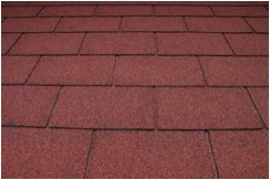 A close-up of an asphalt-shingled roof on a commercial building